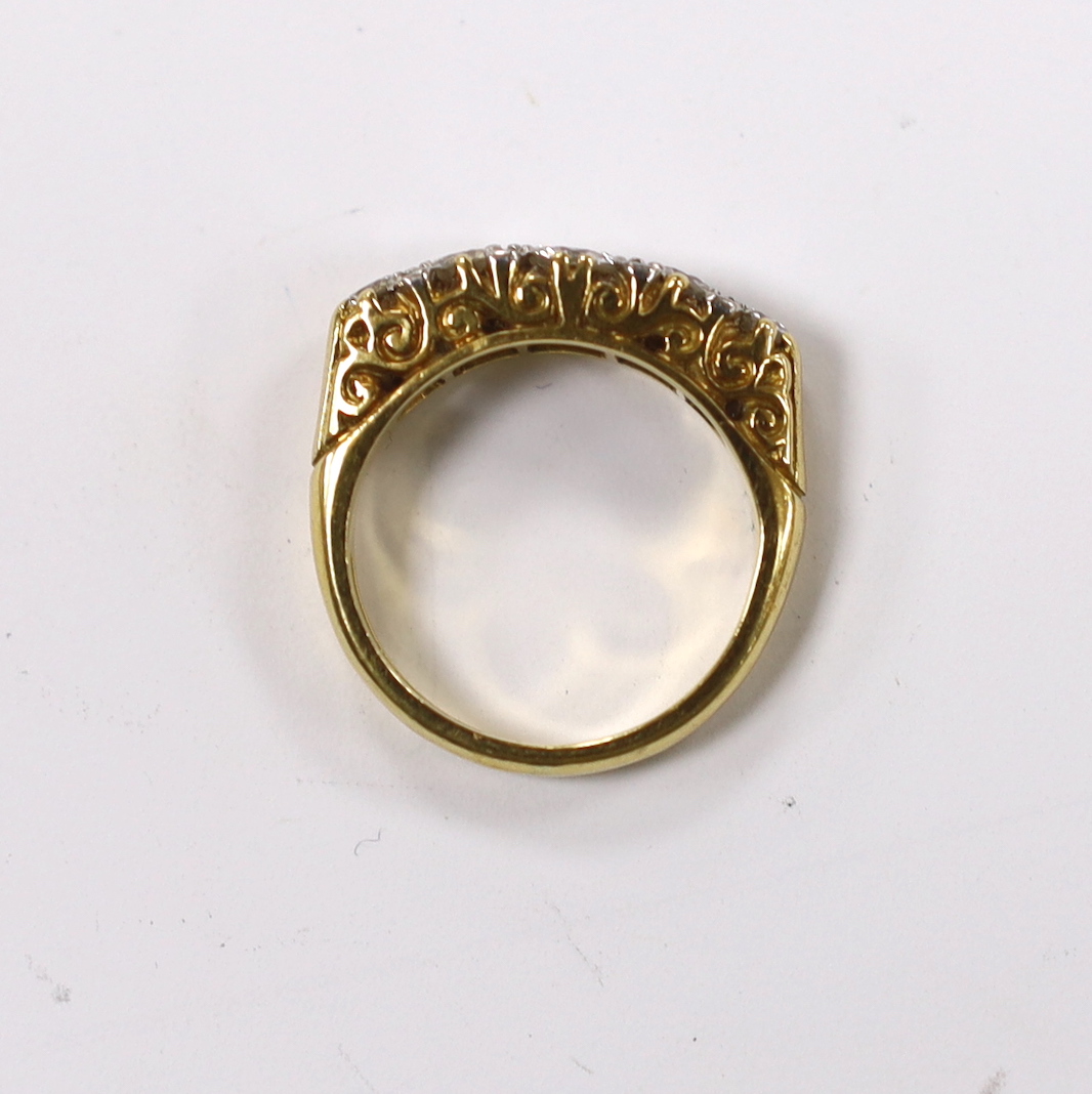 A modern 18ct gold and graduated five stone diamond set half hoop ring, size G, gross weight 5.2 grams.
